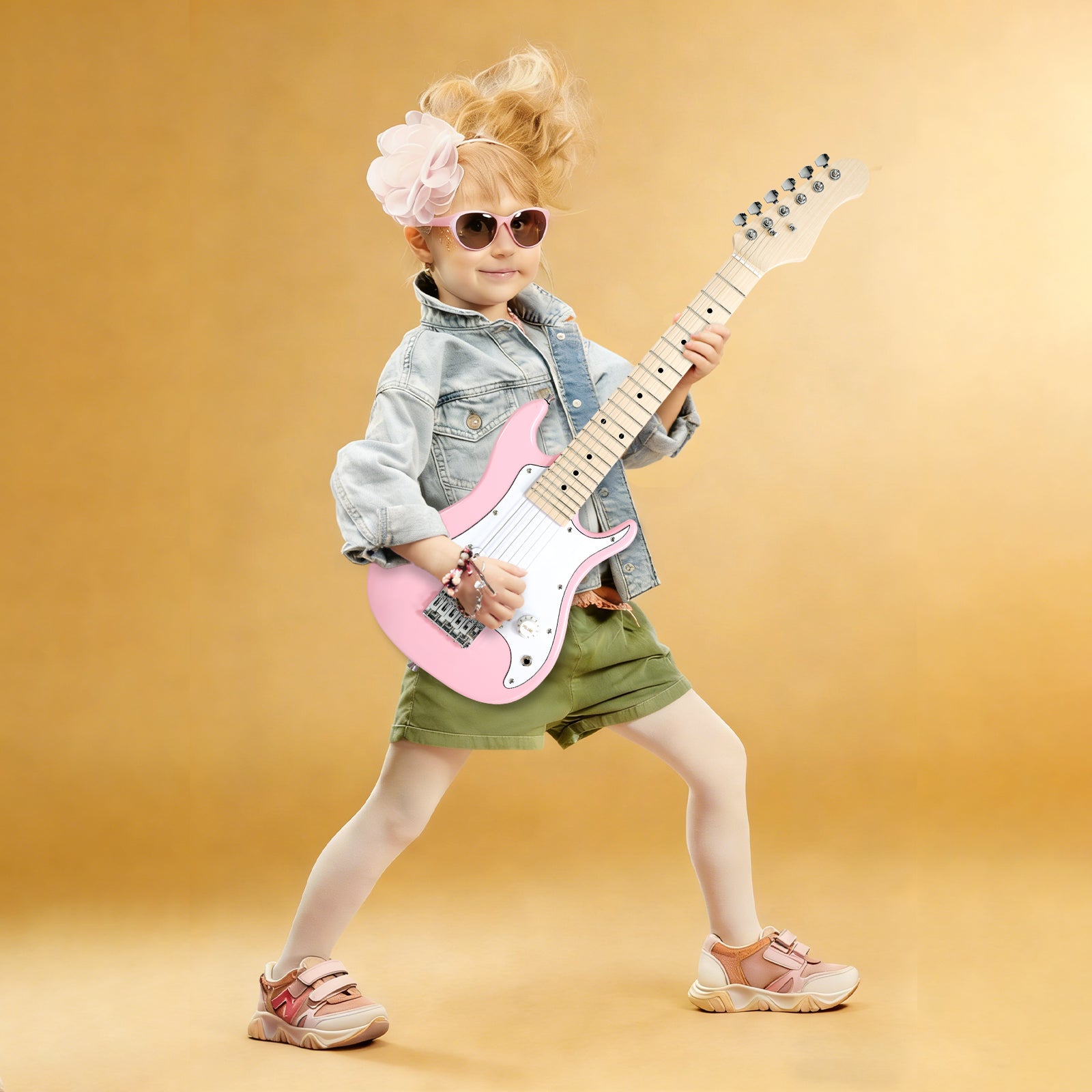 Young girl playing GOLDRIFF 30-inch pink kids electric guitar, perfect mini beginner guitar for children ages 3 to 9