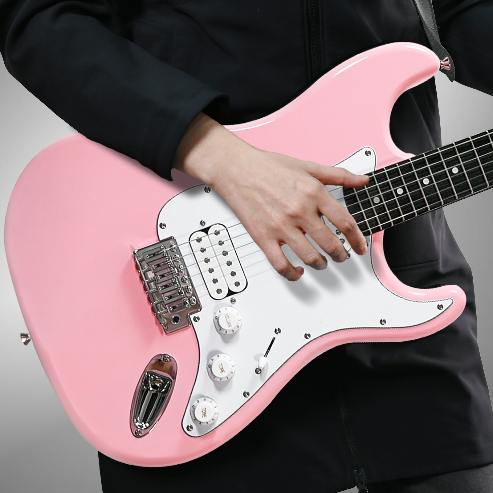 Musician playing GOLDRIFF 39-inch pink stratocaster-style electric guitar, showing HSS pickups and white pickguard#color_pink
