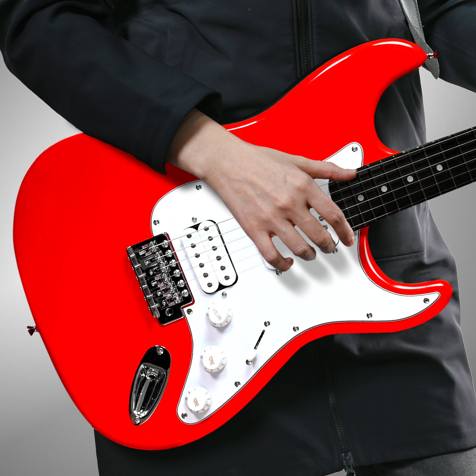 Musician playing GOLDRIFF 39-inch red stratocaster-style electric guitar, showing HSS pickups and white pickguard#color_red